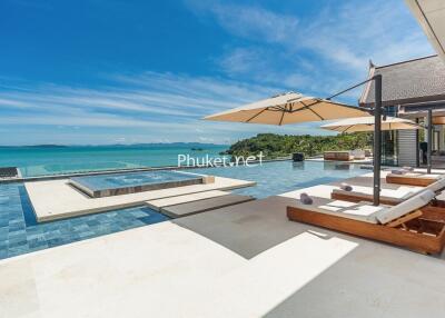 Modern pool area with lounge chairs and ocean view