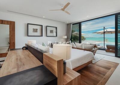 Modern bedroom with ocean view and patio access