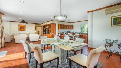 Spacious open-plan dining area with modern furnishings and well-lit ambiance