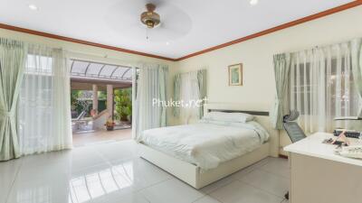 Spacious bedroom with light decor and patio access