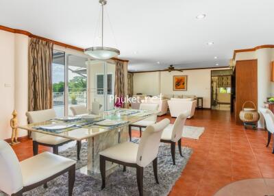 Spacious open-plan dining and living room connected to the kitchen with modern furnishings