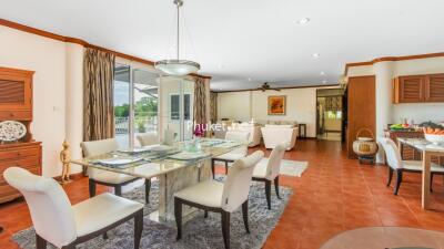 Spacious open-plan dining and living room connected to the kitchen with modern furnishings