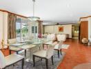 Spacious open-plan dining and living room connected to the kitchen with modern furnishings