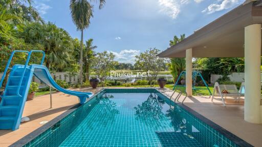 Outdoor swimming pool with slide and patio