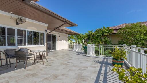 Spacious balcony with seating area and garden view