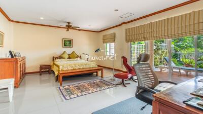 Spacious bedroom with large windows and garden view