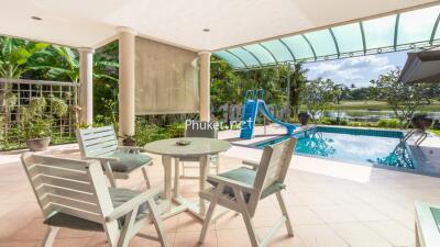 Outdoor patio area with pool and garden view