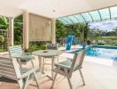 Outdoor patio area with pool and garden view