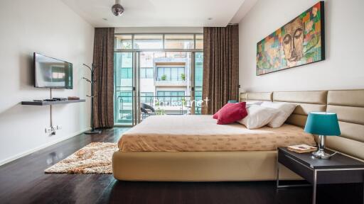 Modern bedroom with a comfortable bed and balcony access