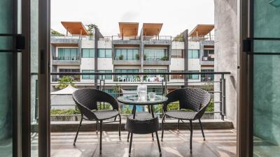 Balcony with outdoor seating and view of neighboring buildings