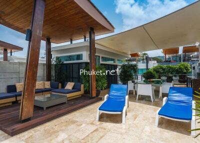 Modern outdoor area with lounge furniture and sun loungers