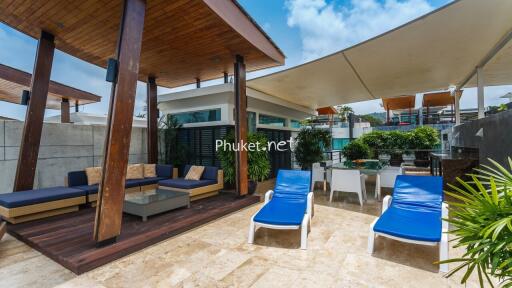 Modern outdoor area with lounge furniture and sun loungers