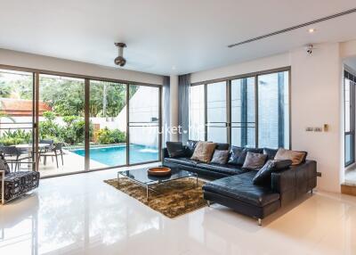 Spacious living room with outdoor pool view