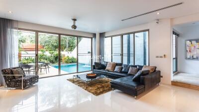 Spacious living room with outdoor pool view