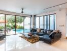 Spacious living room with outdoor pool view