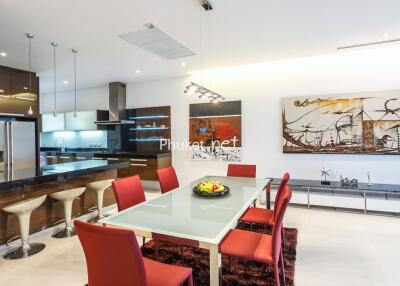 Modern kitchen and dining area with red chairs and contemporary decor