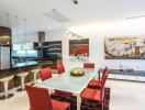 Modern kitchen and dining area with red chairs and contemporary decor