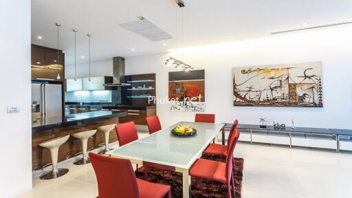 Modern kitchen and dining area with red chairs and contemporary decor