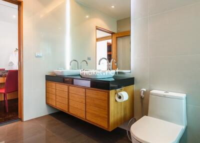 Modern bathroom with dual sinks and toilet