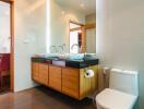 Modern bathroom with dual sinks and toilet