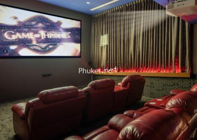 Home theater with red chairs and large screen displaying Game of Thrones
