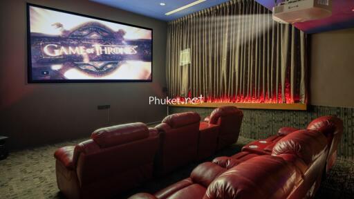 Home theater with red chairs and large screen displaying Game of Thrones