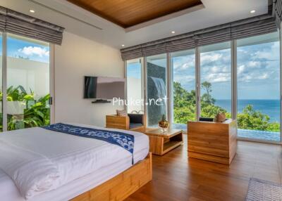 Bedroom with a sea view, contemporary furniture, and large windows