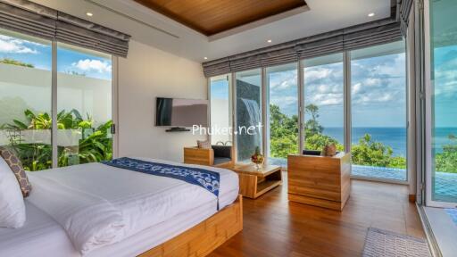 Bedroom with a sea view, contemporary furniture, and large windows