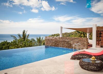 Infinity pool with ocean view and lounging area