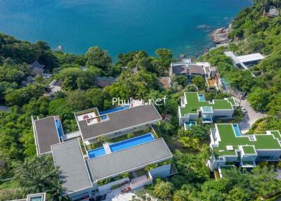 Aerial view of oceanfront properties with pools and lush greenery