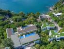 Aerial view of oceanfront properties with pools and lush greenery