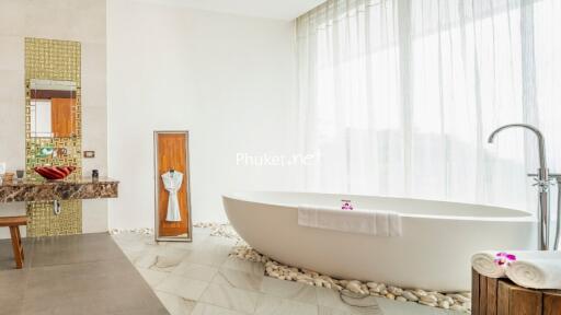 Modern bathroom with freestanding bathtub and large windows