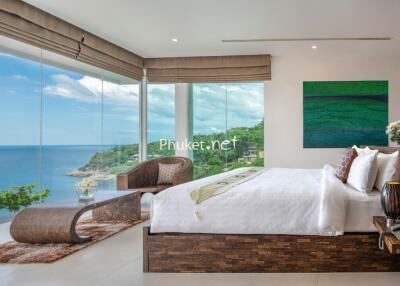 Modern bedroom with floor-to-ceiling windows and ocean view