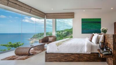 Modern bedroom with floor-to-ceiling windows and ocean view