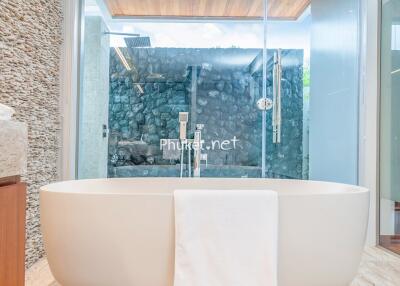 Modern bathroom with freestanding bathtub and glass shower enclosure