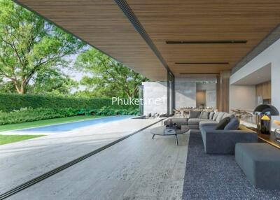 Modern living area with open view to a garden and swimming pool