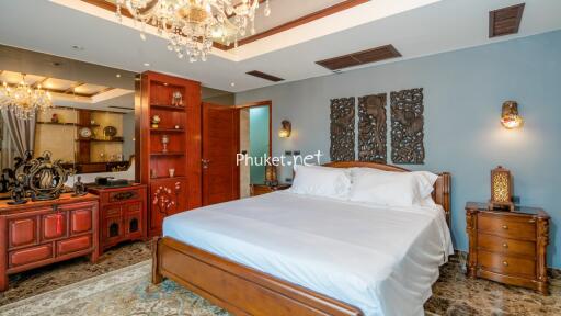 Spacious bedroom with decorative elements and wooden furniture