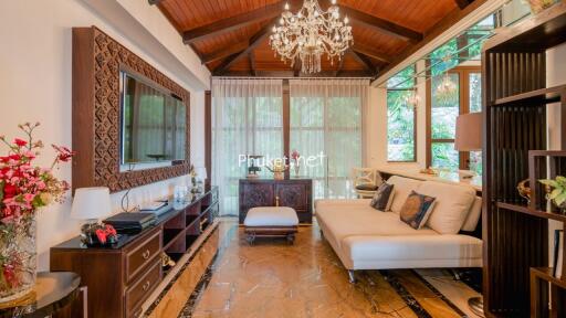 Elegant and spacious living room with chandelier and wooden ceiling