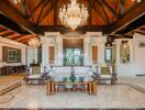 Spacious living room with high wooden ceilings and elegant chandeliers