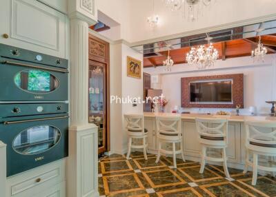 Elegant kitchen with bar seating and chandeliers