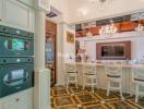 Elegant kitchen with bar seating and chandeliers