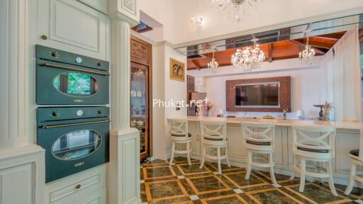 Elegant kitchen with bar seating and chandeliers