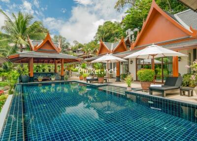 luxury outdoor pool area with traditional architecture