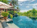 Infinity pool with tropical landscape and patio area