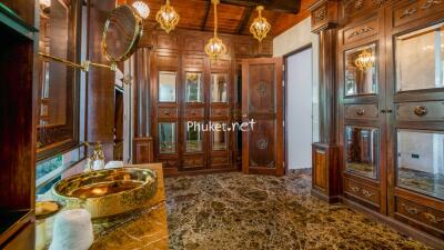 Luxurious bathroom with ornate wooden cabinets and marble flooring