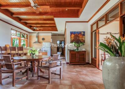 Spacious dining area with wooden ceiling and modern decor