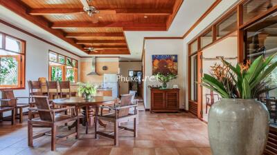 Spacious dining area with wooden ceiling and modern decor