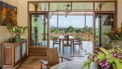 Indoor dining area leading to an outdoor patio with a scenic view