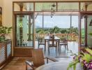 Indoor dining area leading to an outdoor patio with a scenic view