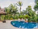 Outdoor pool area with lush landscaping and traditional architecture